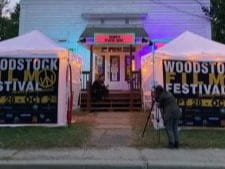 Filming in front of a Woodstock Film Festival pop-up booth.