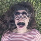 Photo of woman wearing Grouch Mark glasses and mustache